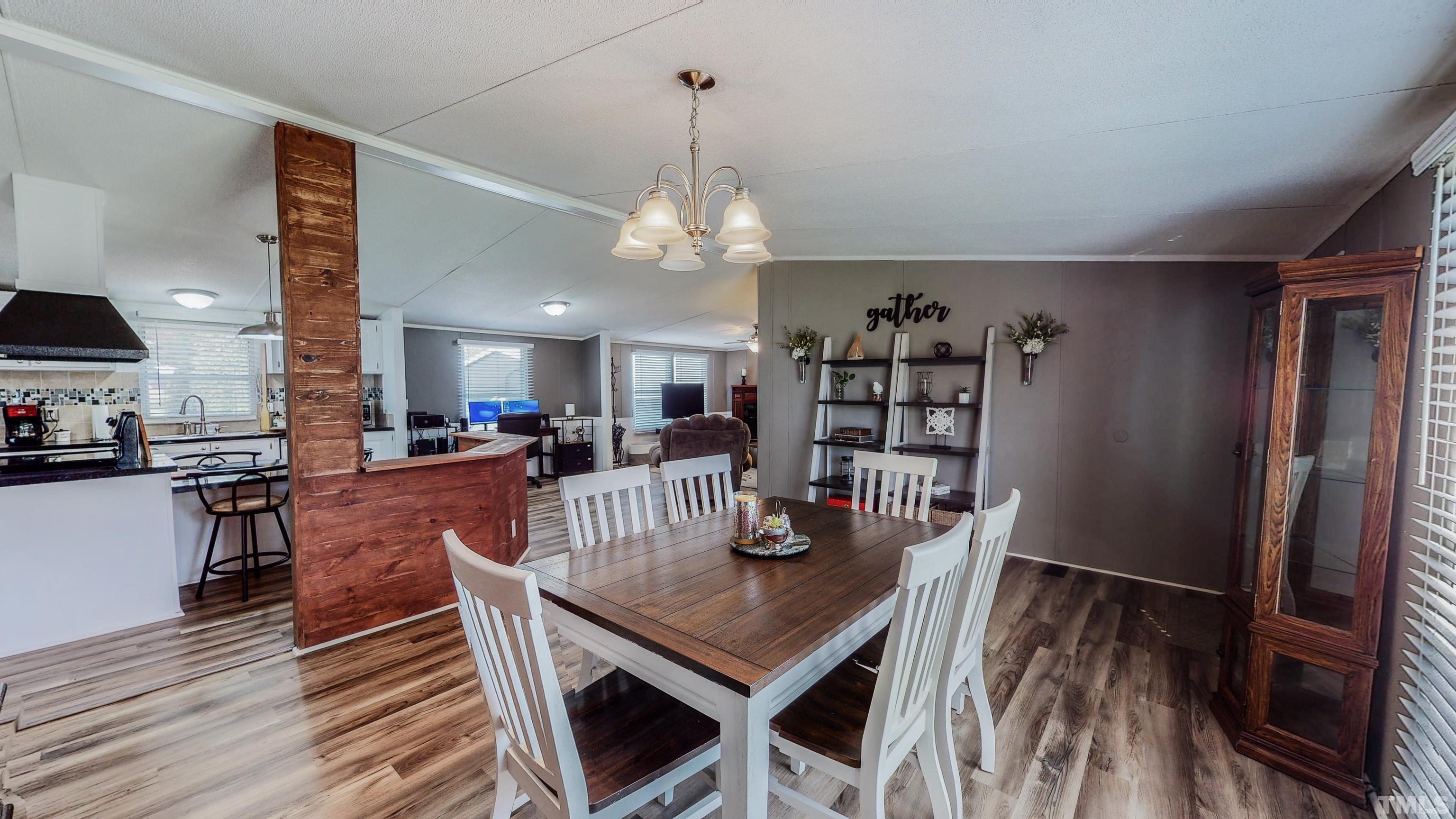 2774 Lucy Garrett Road Timberlake, NC 27583 - Photo 8 of 30 a view of a dining room with furniture and wooden floor