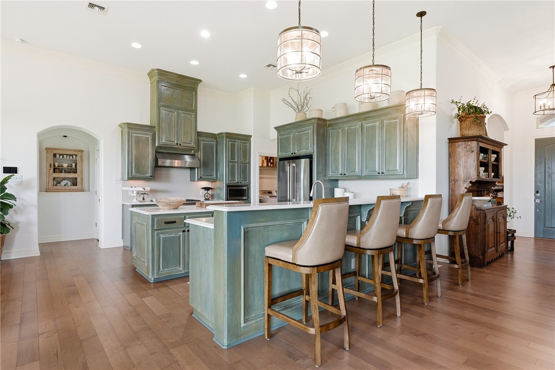 8710 KIng Ranch Drive Corpus Christi, TX 78414 - Photo 11 of 38 a large kitchen with a table and chairs