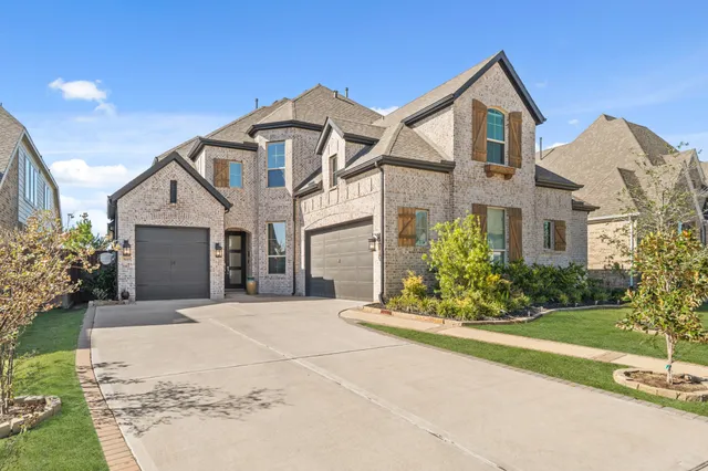 a front view of a house with a garden and plants