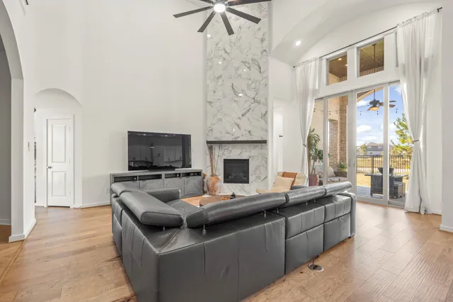 a living room with fireplace furniture and a flat screen tv