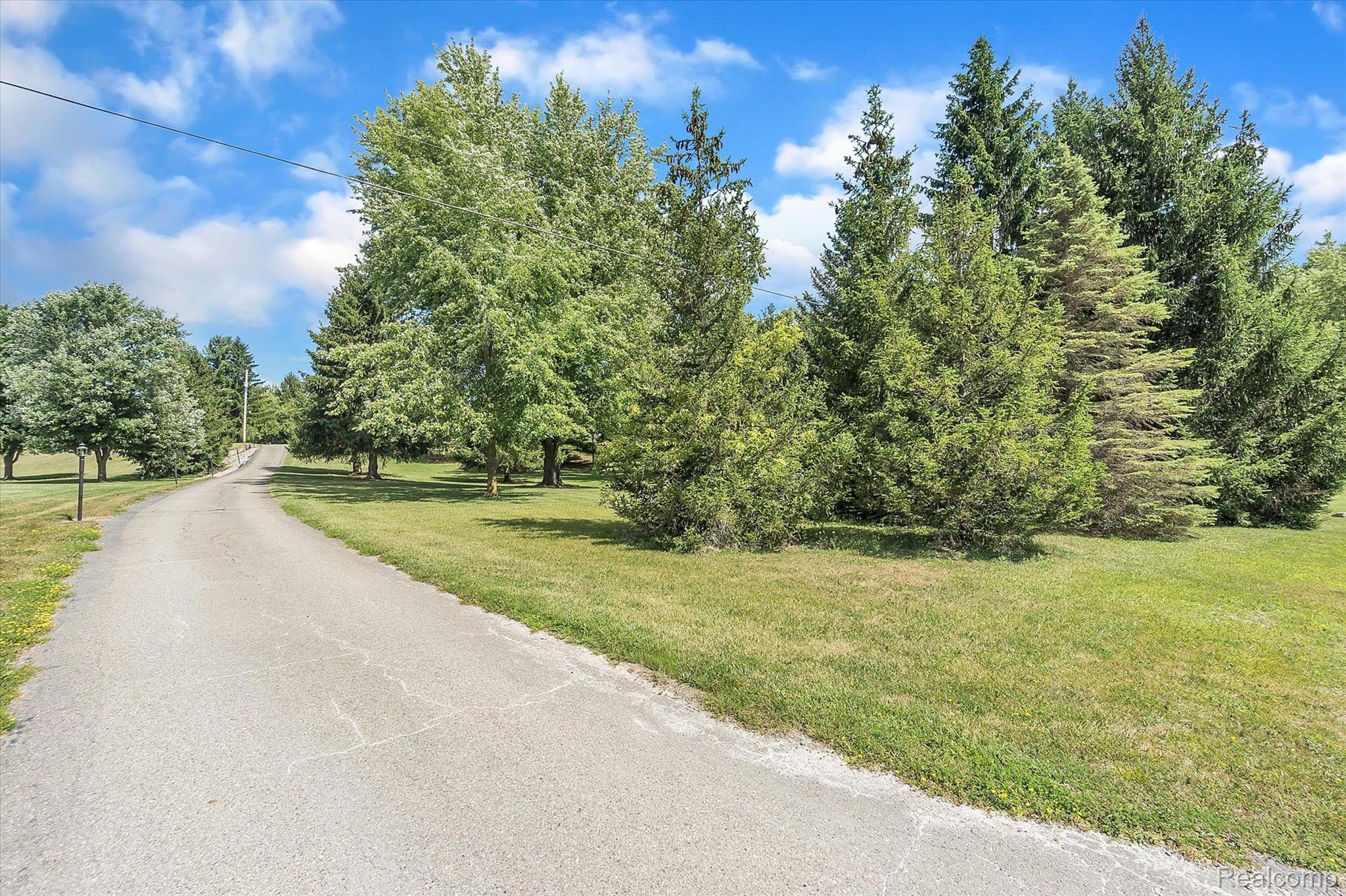 12265 Sharp Road Linden, MI 48451 - Photo 26 of 34 The home is tucked off the road behind the trees