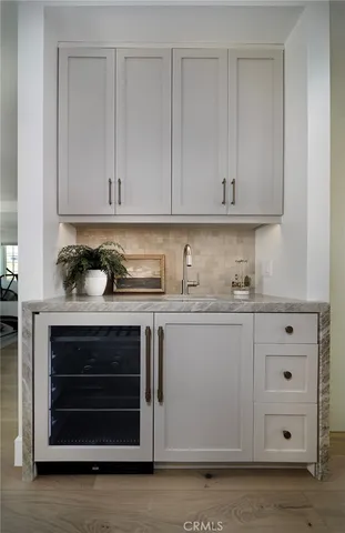 a kitchen with granite countertop white cabinets and stainless steel appliances