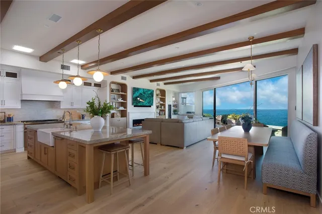 a living room with furniture kitchen view and a chandelier