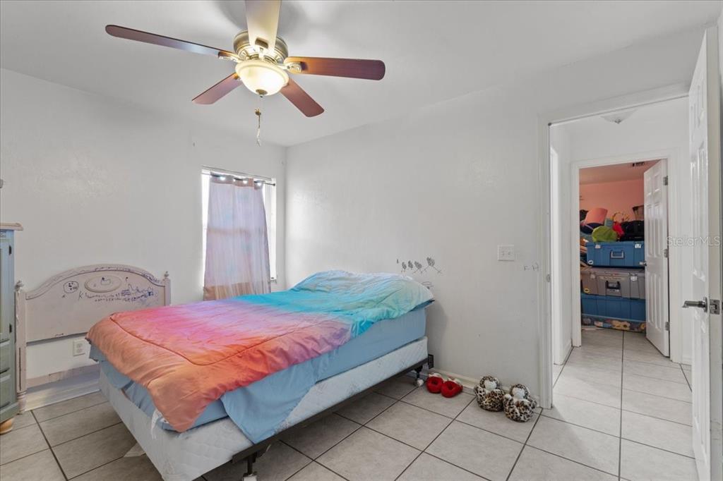 13691 201st Road Live Oak, FL 32060 - Photo 12 of 36 a bedroom with a bed and a chandelier