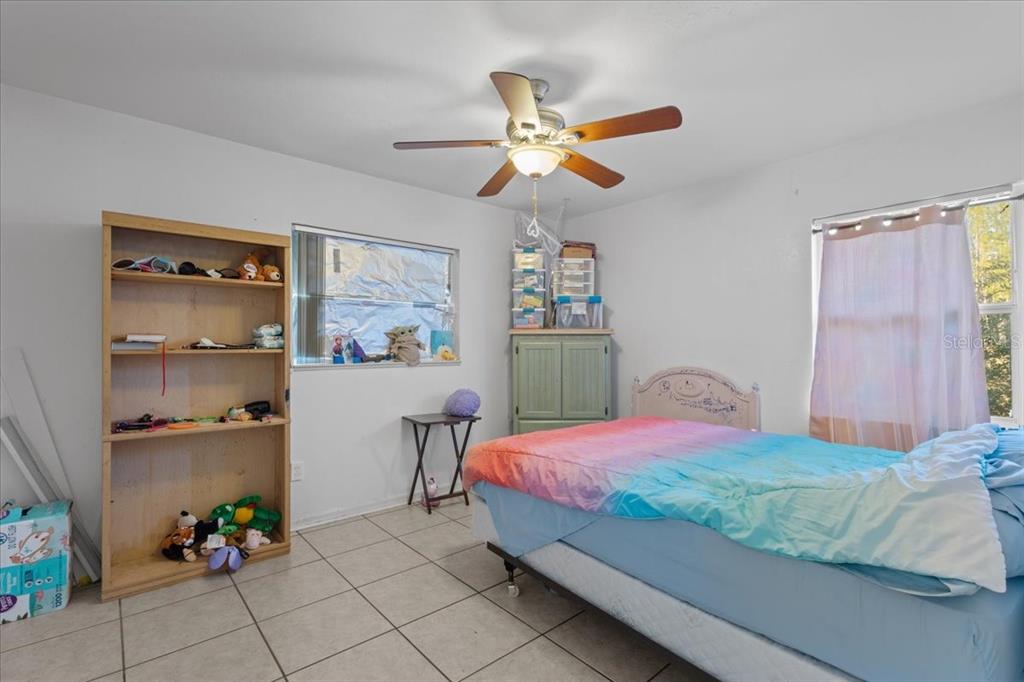 13691 201st Road Live Oak, FL 32060 - Photo 13 of 36 a bedroom with a bed and a chandelier