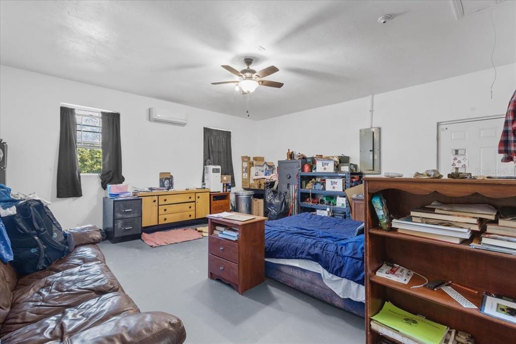 13691 201st Road Live Oak, FL 32060 - Photo 18 of 36 a bedroom with furniture and a chandelier