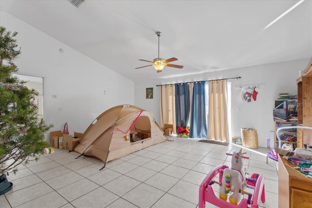 13691 201st Road Live Oak, FL 32060 - Photo 3 of 36 a bed room with a bed and a chair