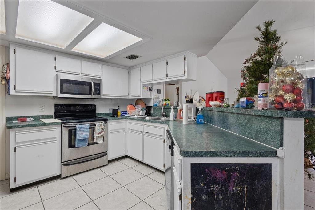 13691 201st Road Live Oak, FL 32060 - Photo 7 of 36 a kitchen with stainless steel appliances granite countertop a stove sink and cabinets