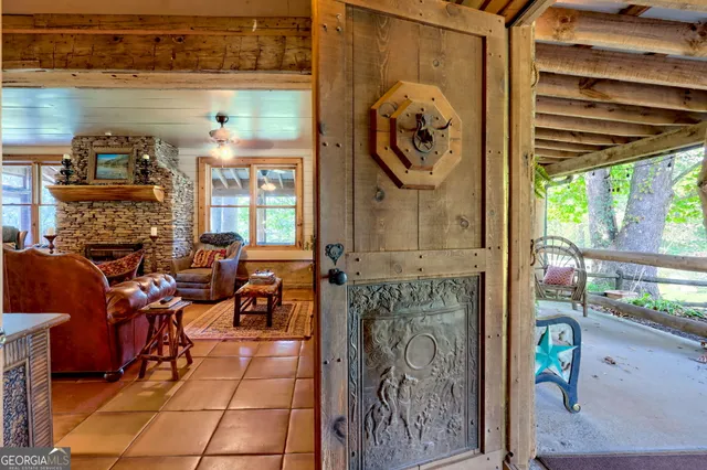 a view of a porch with furniture and a gate