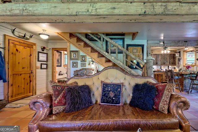 a living room with furniture and floor to ceiling windows