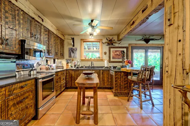 a kitchen with stainless steel appliances granite countertop a refrigerator a stove and a wooden floors