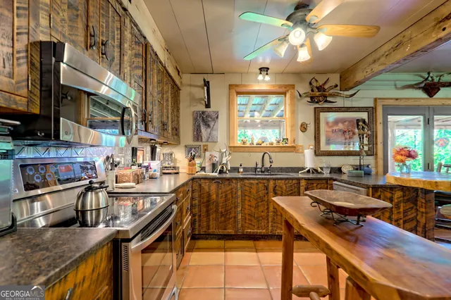 a view of backyard with table and chairs and potted plants