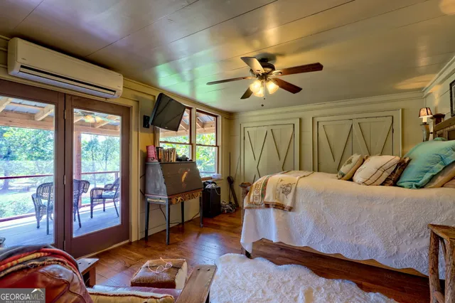 a view of a yard with plants and large trees