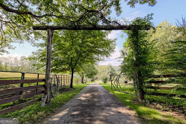 a living room with furniture a fireplace and a chandelier