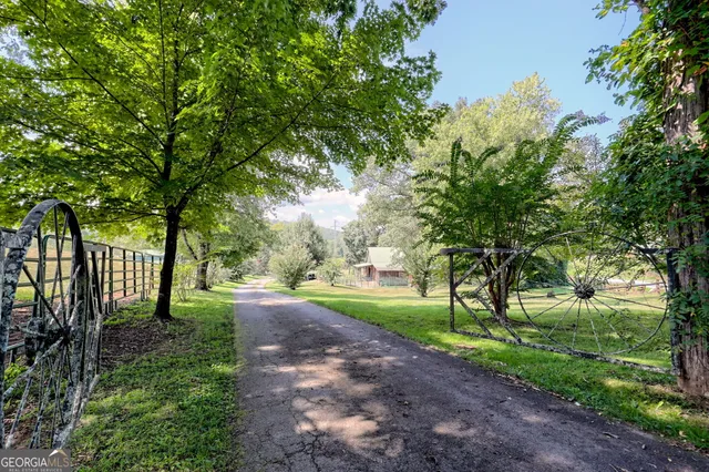 a living room with furniture a chandelier and a large window
