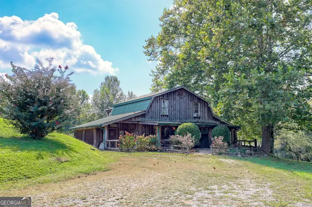 a kitchen with stainless steel appliances granite countertop table chairs sink and cabinets