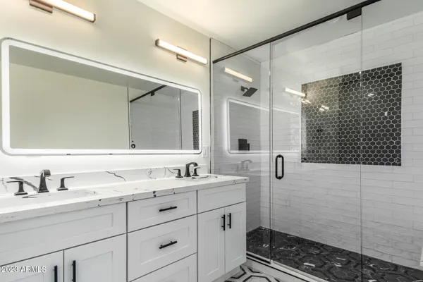 a bathroom with a double vanity sink mirror and toilet