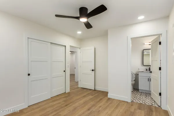wooden floor in an empty room with a kitchen