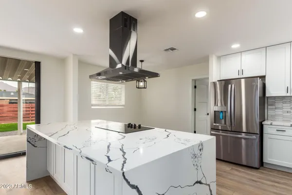 a kitchen with stainless steel appliances a sink stove and refrigerator
