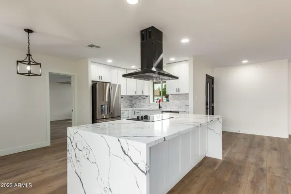 a kitchen with stainless steel appliances kitchen island a island in the center