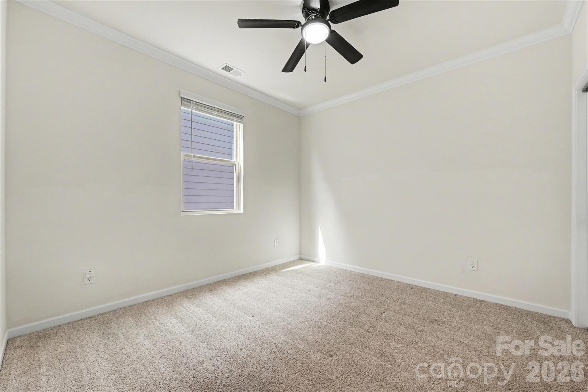 1311 Tollcross Road Indian Trail, NC 28079 - Photo 12 of 34 an empty room with a window and a fan
