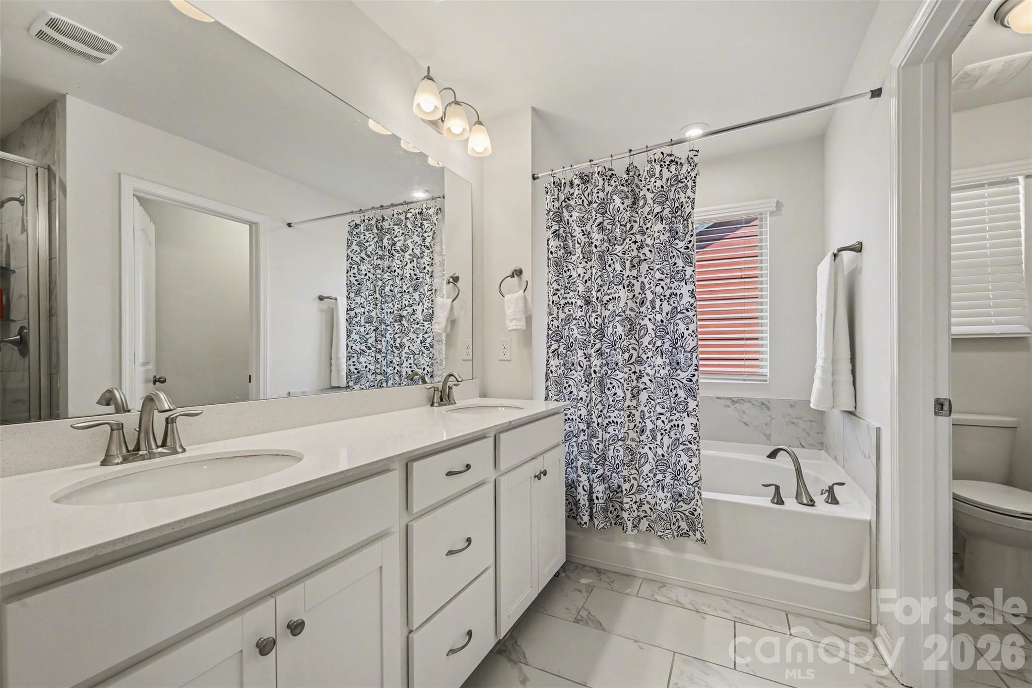 1311 Tollcross Road Indian Trail, NC 28079 - Photo 18 of 34 a bathroom with a double vanity sink mirror and shower