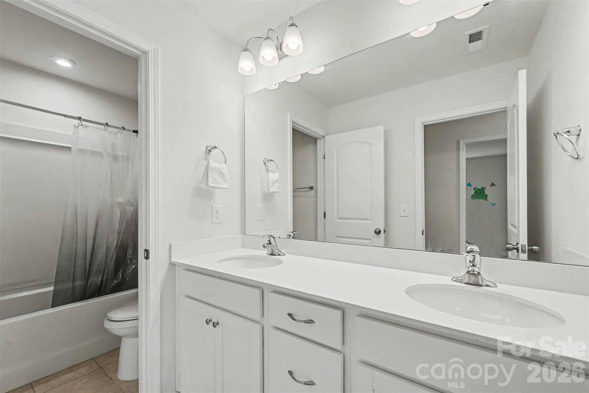 1311 Tollcross Road Indian Trail, NC 28079 - Photo 21 of 34 a bathroom with a double vanity sink toilet and shower