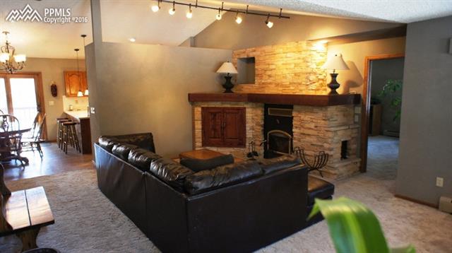 9925 Walker Road Colorado Springs, CO 80908 - Photo 7 of 20 MAIN LEVEL LIVING ROOM WITH WOOD BURNING FIREPLACE