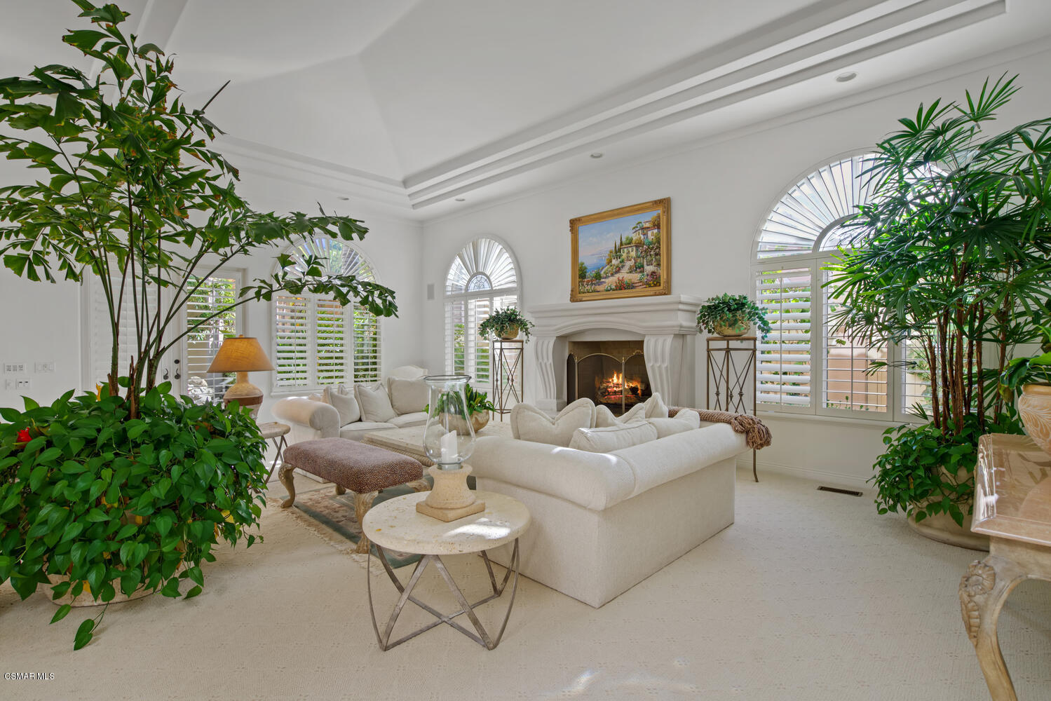 6021 John Muir Road Hidden Hills, CA 91302 - Photo 19 of 74 a living room with furniture a fireplace and a potted plant
