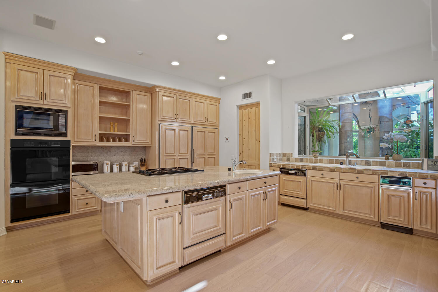 6021 John Muir Road Hidden Hills, CA 91302 - Photo 28 of 74 a large white kitchen with stainless steel appliances granite countertop a stove and a sink