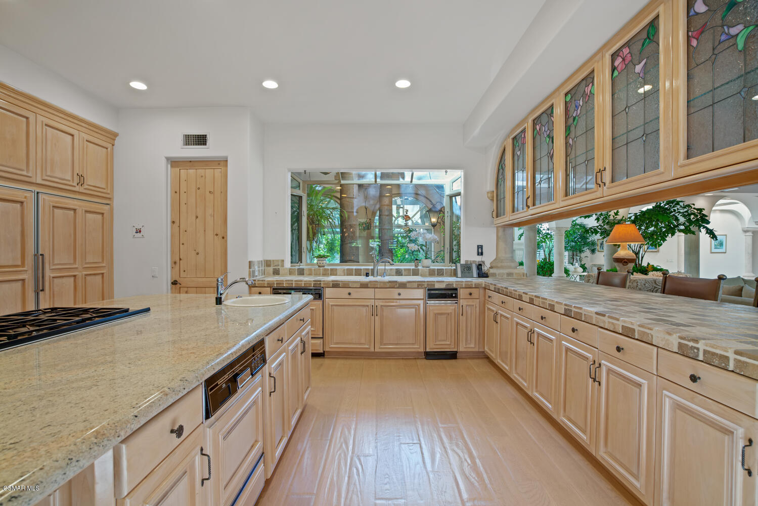 6021 John Muir Road Hidden Hills, CA 91302 - Photo 29 of 74 a large white kitchen with a large window