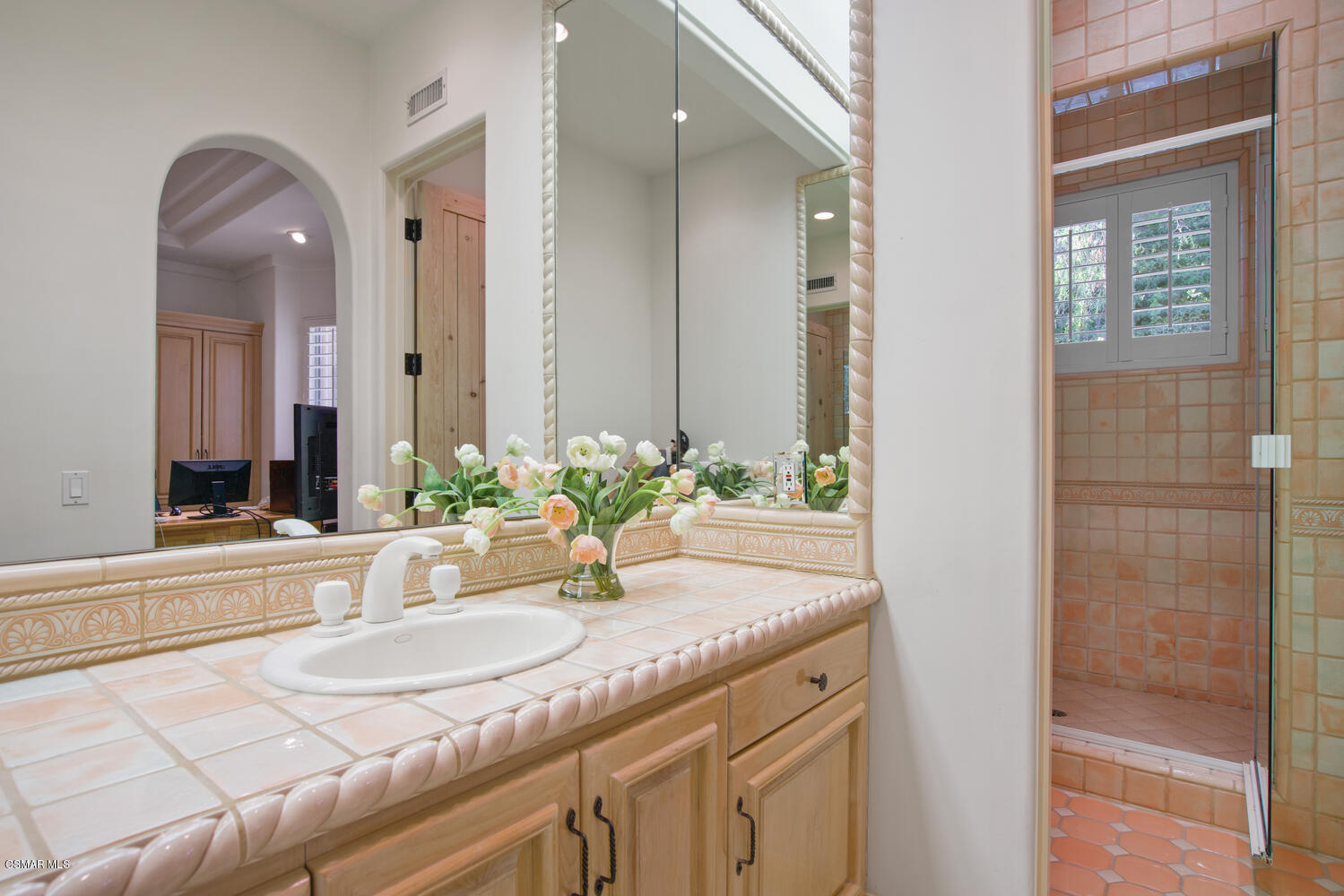 6021 John Muir Road Hidden Hills, CA 91302 - Photo 40 of 74 a bathroom with a granite countertop sink and a mirror