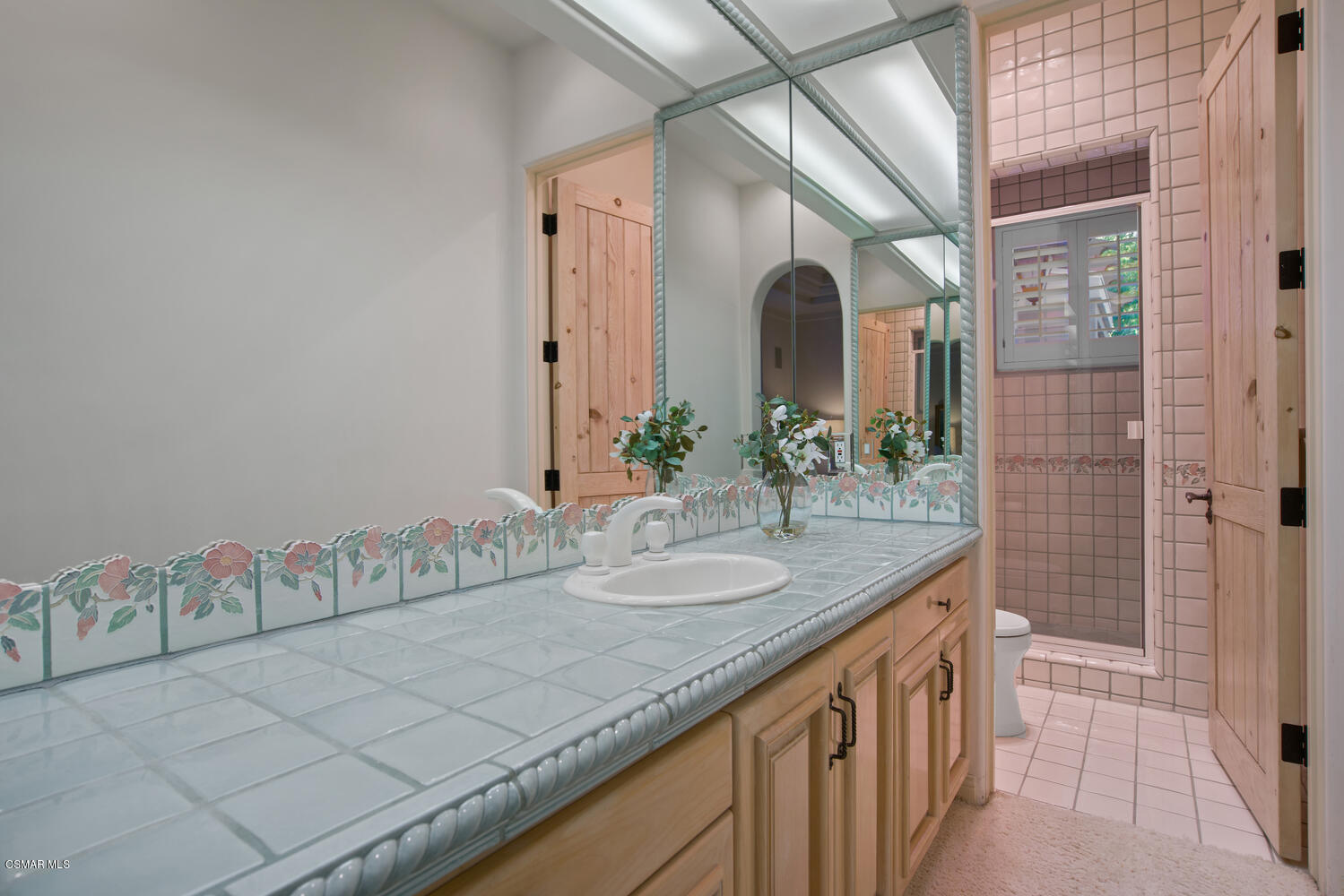6021 John Muir Road Hidden Hills, CA 91302 - Photo 42 of 74 a bathroom with a granite countertop sink and a mirror