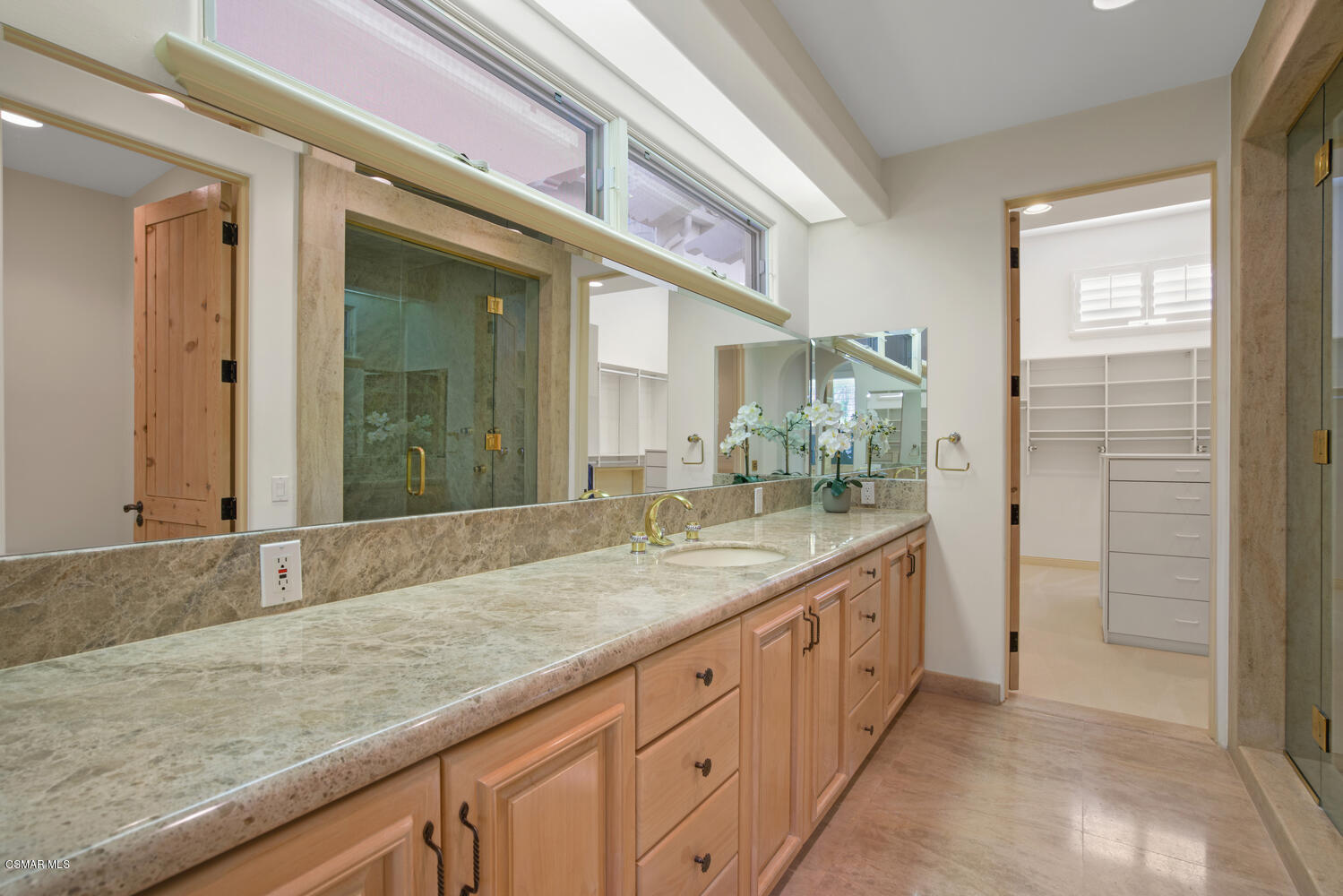 6021 John Muir Road Hidden Hills, CA 91302 - Photo 54 of 74 a spacious bathroom with a granite countertop sink and a mirror