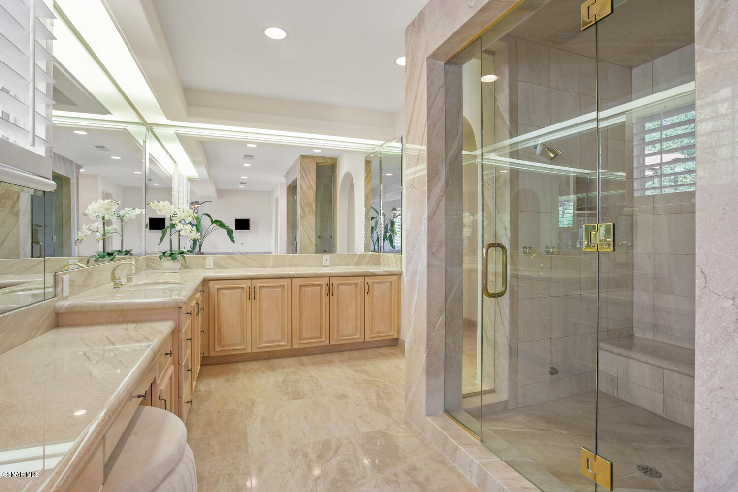 6021 John Muir Road Hidden Hills, CA 91302 - Photo 56 of 74 a bathroom with a granite countertop sink a mirror and shower