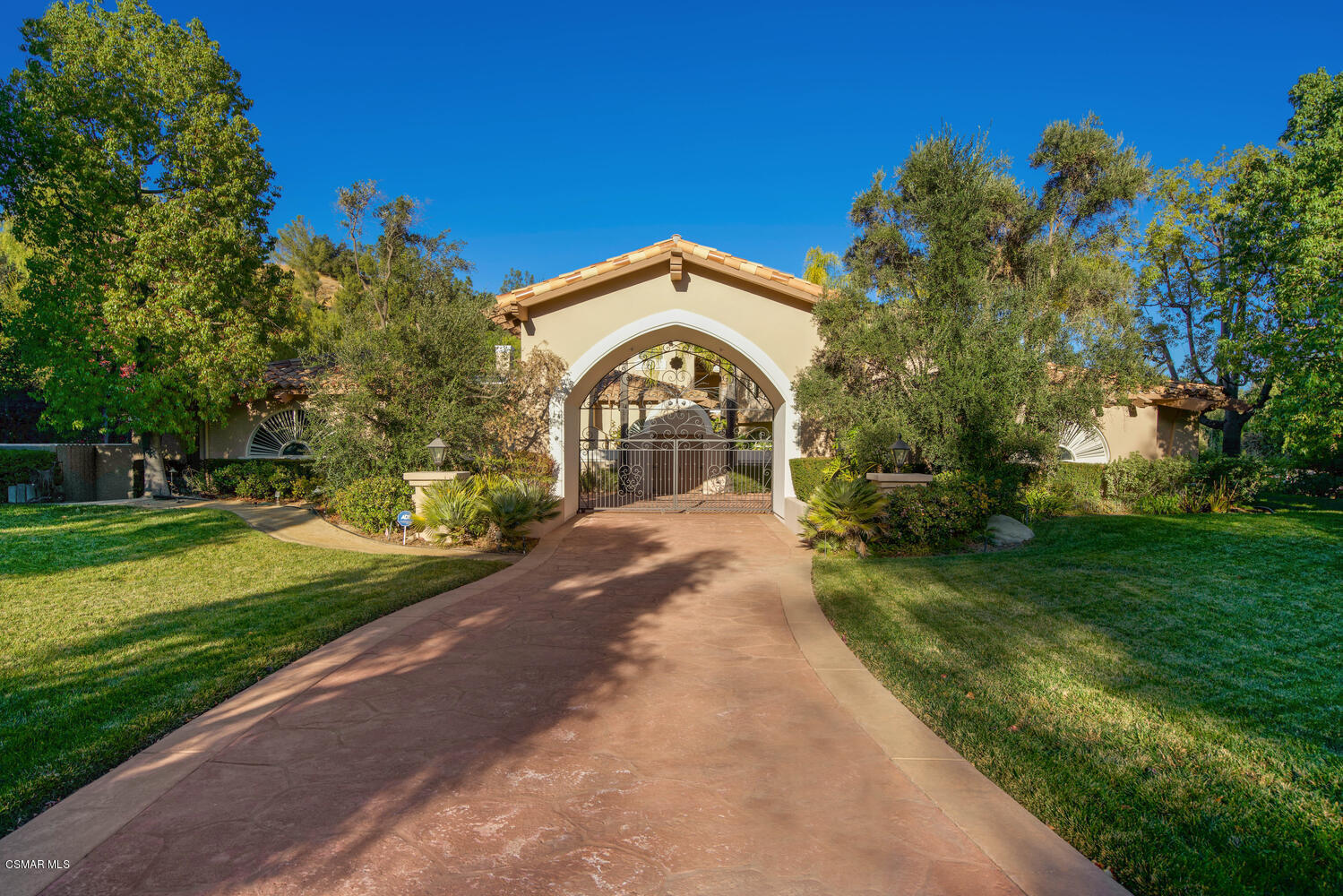 6021 John Muir Road Hidden Hills, CA 91302 - Photo 7 of 74 a front view of a house with a yard