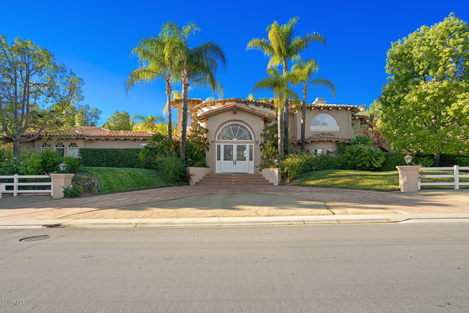 6021 John Muir Road Hidden Hills, CA 91302 - Photo 8 of 74 a front view of a house with a yard and a garage