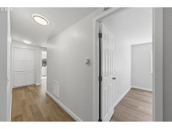 a view of a hallway with wooden floor