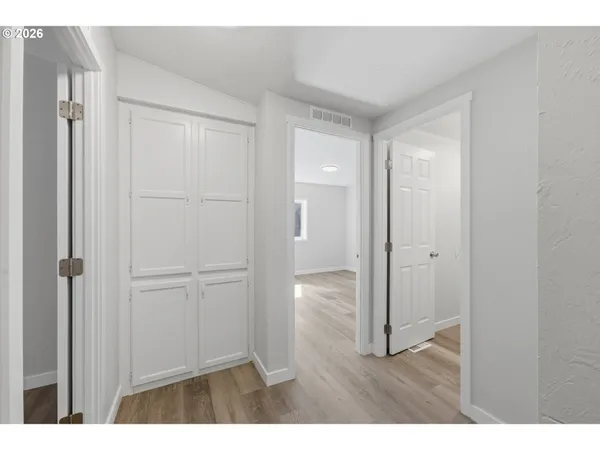 a view of an empty room with wooden floor