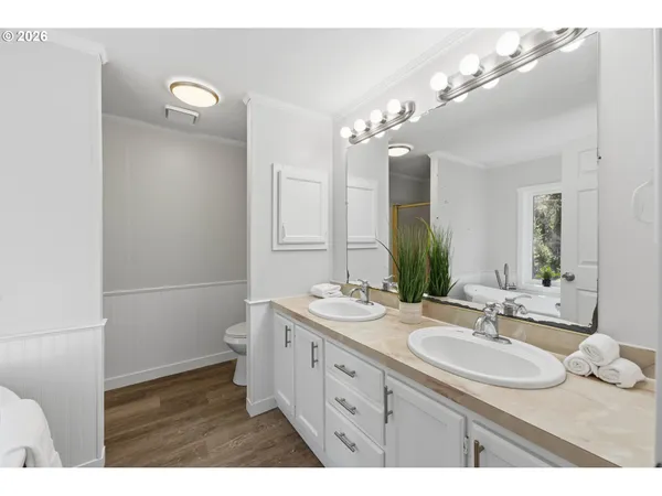 a bathroom with a sink double vanity granite and a mirror