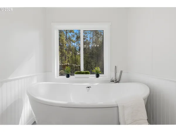 a bathroom with a bathtub and a window