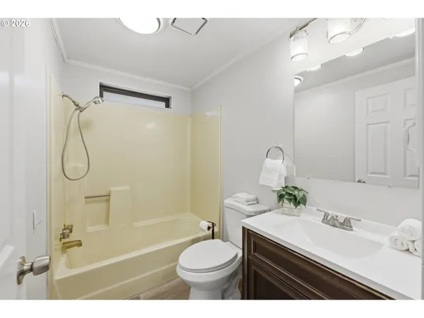 a bathroom with a sink toilet tub and shower