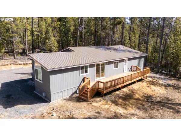 a aerial view of a house with a yard and sitting area