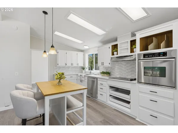 a kitchen with a table chairs and microwave