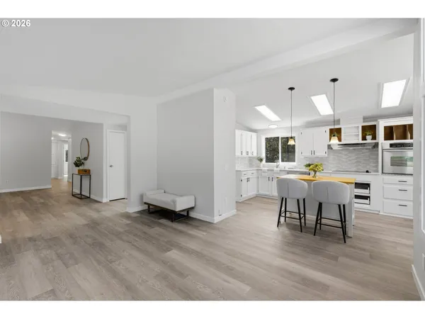 a open kitchen with cabinets table and chairs