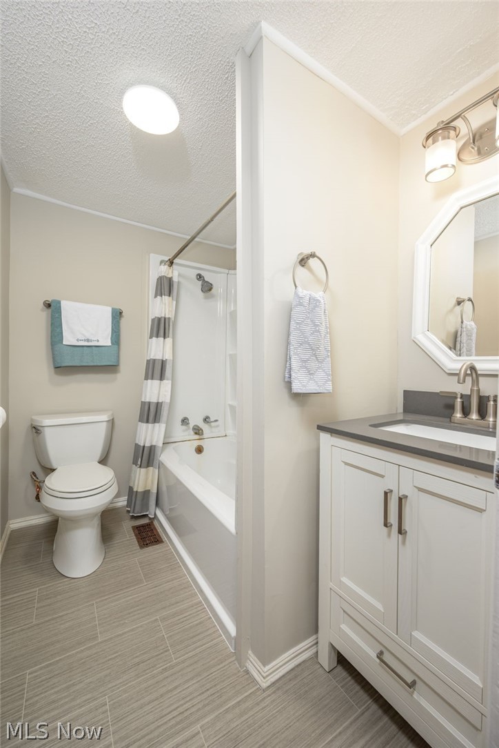 1069 West Nimisila Road New Franklin, OH 44216 - Photo 15 of 26 This bathroom features a white vanity with a dark countertop, a white toilet, and a white bathtub with a shower
