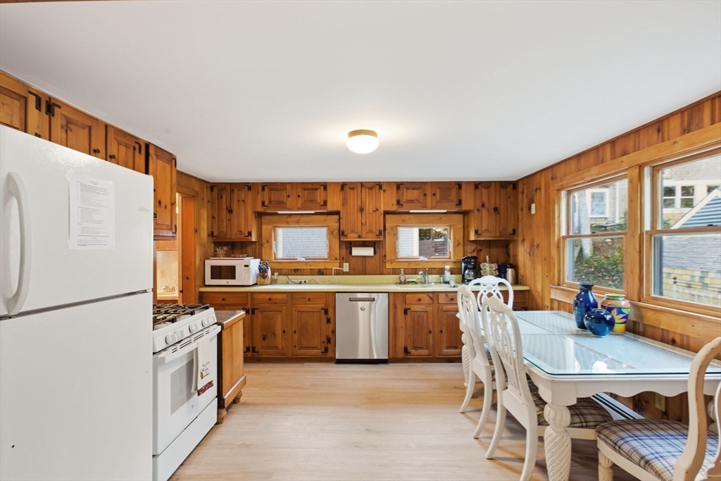 3 W Road Sandwich, MA 02644 - Photo 8 of 15 a kitchen with stainless steel appliances granite countertop a stove refrigerator sink and chairs