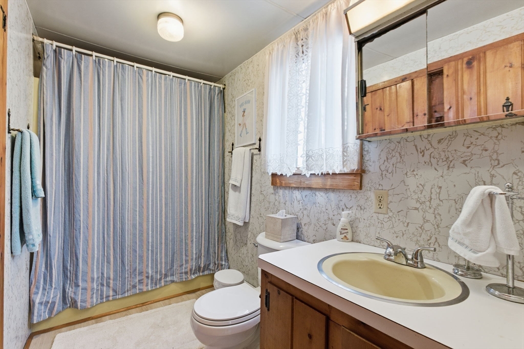 3 W Road Sandwich, MA 02644 - Photo 10 of 15 a bathroom with a granite countertop sink and a mirror
