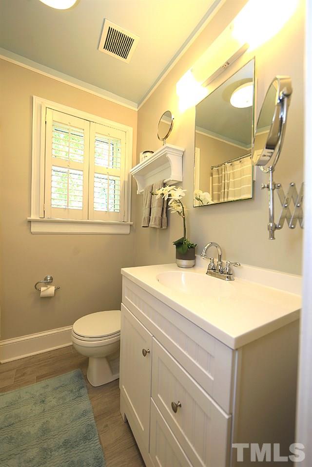 2812 Barmettler Street Raleigh, NC 27607 - Photo 14 of 28 a bathroom with a granite countertop sink mirror vanity and toilet