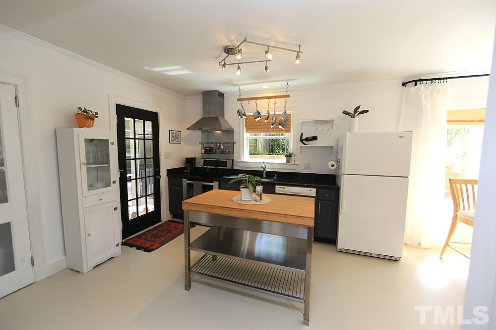 2812 Barmettler Street Raleigh, NC 27607 - Photo 8 of 28 a kitchen with stainless steel appliances granite countertop a refrigerator and a sink